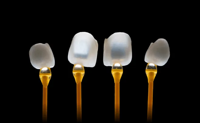 Four dental veneers on holders